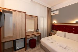 Postel nebo postele na pokoji v ubytování Olimpic Hotel