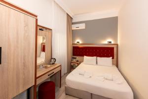 Postel nebo postele na pokoji v ubytování Olimpic Hotel