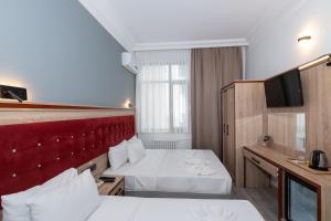 Postel nebo postele na pokoji v ubytování Olimpic Hotel