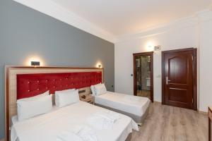 Postel nebo postele na pokoji v ubytování Olimpic Hotel