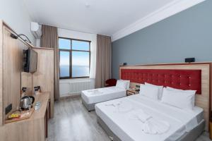 Postel nebo postele na pokoji v ubytování Olimpic Hotel