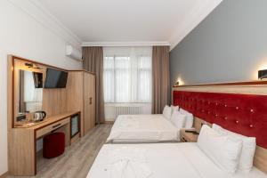 Postel nebo postele na pokoji v ubytování Olimpic Hotel