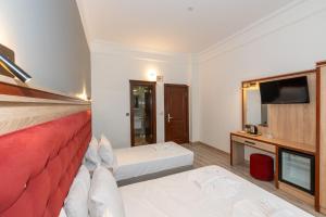TV a/nebo společenská místnost v ubytování Olimpic Hotel