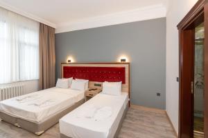 Postel nebo postele na pokoji v ubytování Olimpic Hotel