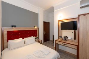 Postel nebo postele na pokoji v ubytování Olimpic Hotel