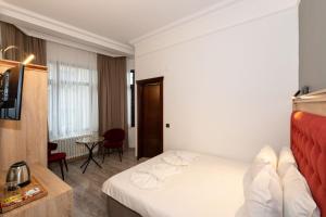 Postel nebo postele na pokoji v ubytování Olimpic Hotel