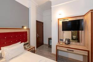 Postel nebo postele na pokoji v ubytování Olimpic Hotel