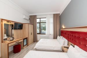 TV a/nebo společenská místnost v ubytování Olimpic Hotel