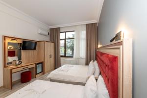 Postel nebo postele na pokoji v ubytování Olimpic Hotel