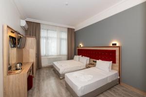 Postel nebo postele na pokoji v ubytování Olimpic Hotel