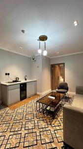 a living room with a couch and a table at فندق فاتوران vatoran hotel in Al Madinah