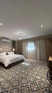 a bedroom with a large bed in a room with a large sqor sqor at فندق فاتوران vatoran hotel in Al Madinah