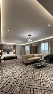 a large living room with a couch and tables at فندق فاتوران vatoran hotel in Al Madinah