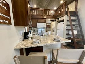 a kitchen with a large island in a tiny house at Breathtaking Tiny House Settled Between Trees in Tracy City, Tennessee in Tracy City +8 photos