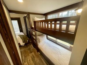 a small bedroom with a bunk bed and a window at Breathtaking Tiny House Settled Between Trees in Tracy City, Tennessee in Tracy City