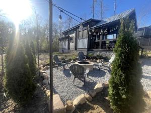 a backyard with a fire pit and a house at Breathtaking Tiny House Settled Between Trees in Tracy City, Tennessee in Tracy City