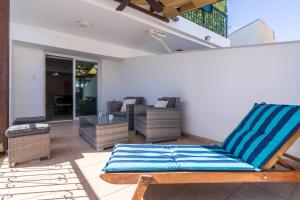a patio with a chair and a table at Carisa flat, 2 bedrooms in Larnaca