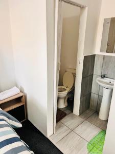 a bathroom with a toilet and a sink at Linies guest house northmead in Benoni +42 photos