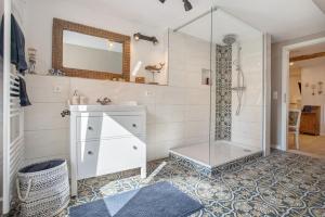 a bathroom with a shower and a sink and a mirror at Urlaub unterm Reetdach in Fuhlendorf +23 photos