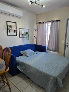 a bedroom with a blue bed and a blue couch at Blue House - Sleeps 5 - Near Hermosa Beach in Puerto Peñasco