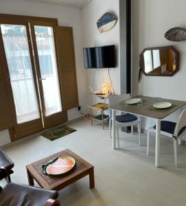 a living room with a table and a dining room at Loft with terrace in Tossa in Tossa de Mar