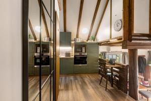 a kitchen with green cabinets and a table in it at Ferienhaus Rotkäppchen in Frankenau