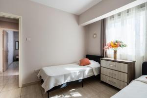 a hospital room with two beds and a window at Carisa flat, 2 bedrooms in Larnaca