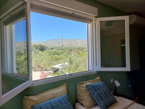 a room with a large window and a couch with pillows at B&B Casa Vitalidad in Ontinyent