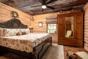 sypialnia z łóżkiem w chacie z bali w obiekcie Magical Treehouse with Slide by Brazos River for Family Glamping Adventures in Texas w mieście Buckner