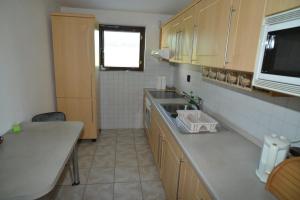 a kitchen with a sink and a counter top at Chalupa Na Vejhonu Jižná in Pluhův Žďár +4 photos