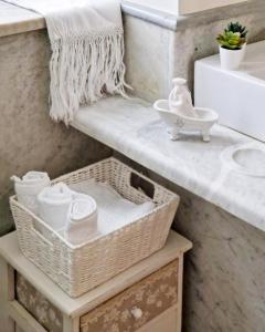 a bathroom with baskets and a sink and a counter at Casa Al Plumbago in Termini Imerese +55 photos