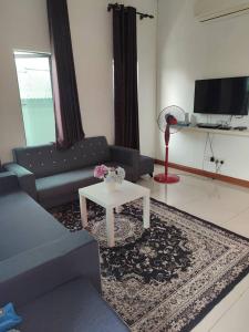 a living room with a couch and a table at Homestay Haji Ismail selayang 2025 mvslim only 3R2B in Batu Caves +18 photos