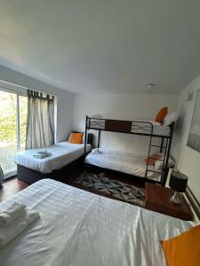 a bedroom with two bunk beds and a window at THE KINGSVIEW TOWNHOUSE - Boutique Hostel in Edinburgh