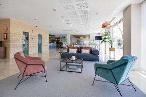 a lobby with two chairs and a couch and a table at Daniya Alicante in Alicante