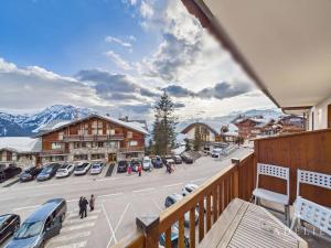 a balcony with a view of a parking lot and mountains at Charmant 3P Centre Station avec Parking et TV - FR-1-398-559 in La Rosière +7 photos