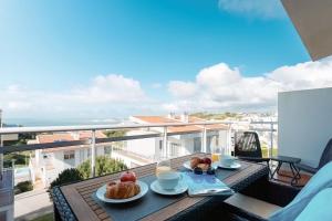 a table with food on top of a balcony at Serene View - By SCH in Alvados