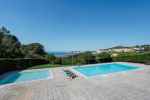 a swimming pool with two lounges and two chairs next to it at Serene View - By SCH in Alvados