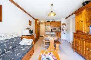 a living room with a couch and a table at Valfréjus La montagne- App 123 in Valfréjus +12 photos