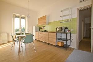 a kitchen with a table and chairs and a microwave at A Casa di Marco in Capua