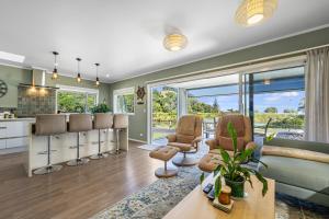 a kitchen and living room with a barber shop at The Lighthouse - Te Mata Holiday Home in Thames
