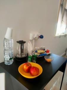 un mostrador con dos manzanas en una placa amarilla en Bed and fly Aeroporto Catania reception, en Catania