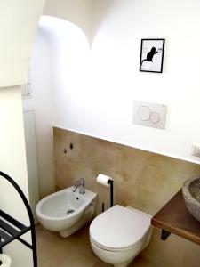 a bathroom with a toilet and a sink at C'era una volta in Modugno +2 photos