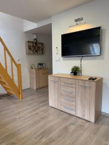 a living room with a large flat screen tv on a wall at Apartmán v blízkosti centra Brna in Brno