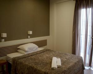 Postel nebo postele na pokoji v ubytování Nafsika Hotel Athens Centre
