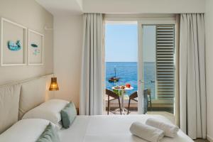 a hotel room with a view of the ocean at Albatros Beach Hotel in Letojanni