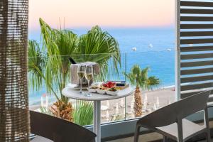 a plate of food on a table in front of a beach at Albatros Beach Hotel in Letojanni