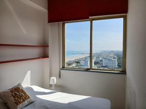 a bedroom with a bed and a large window at CV011 - Milano Marittima, trilocale fronte mare con vista esclusiva in Milano Marittima