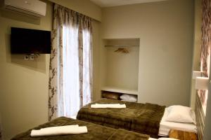 Postel nebo postele na pokoji v ubytování Nafsika Hotel Athens Centre
