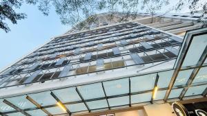 a tall building with lots of windows at Colony Service Suites Kuala Lumpur in Kuala Lumpur