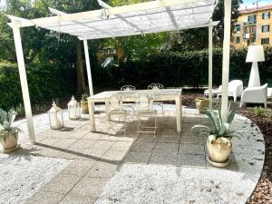 a patio with a table and chairs under a white canopy at Casa Sofia in Bologna